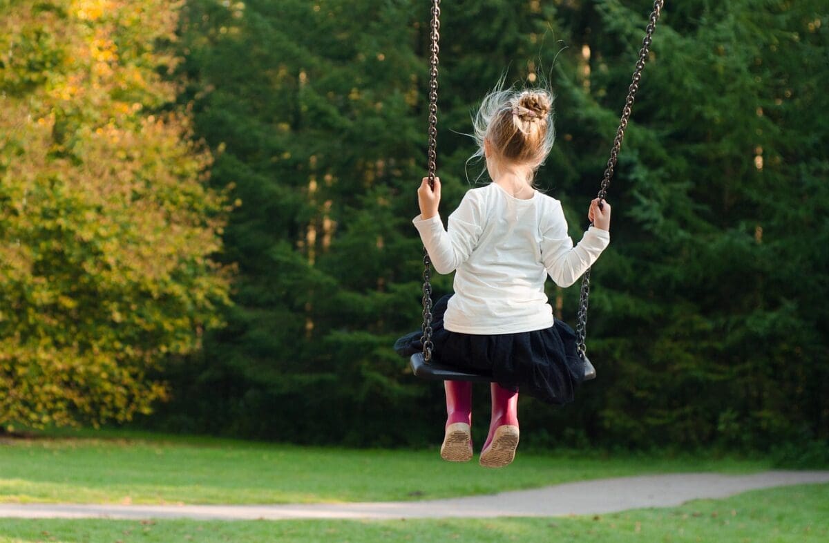 Girl on swing participating in summer activity for kids in Edmonton